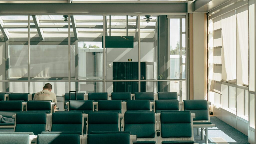 Lichte wachtruimte bij de gate van een luchthaven met rijen stoelen